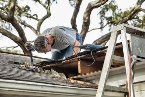 Contractor repairing a roof edge